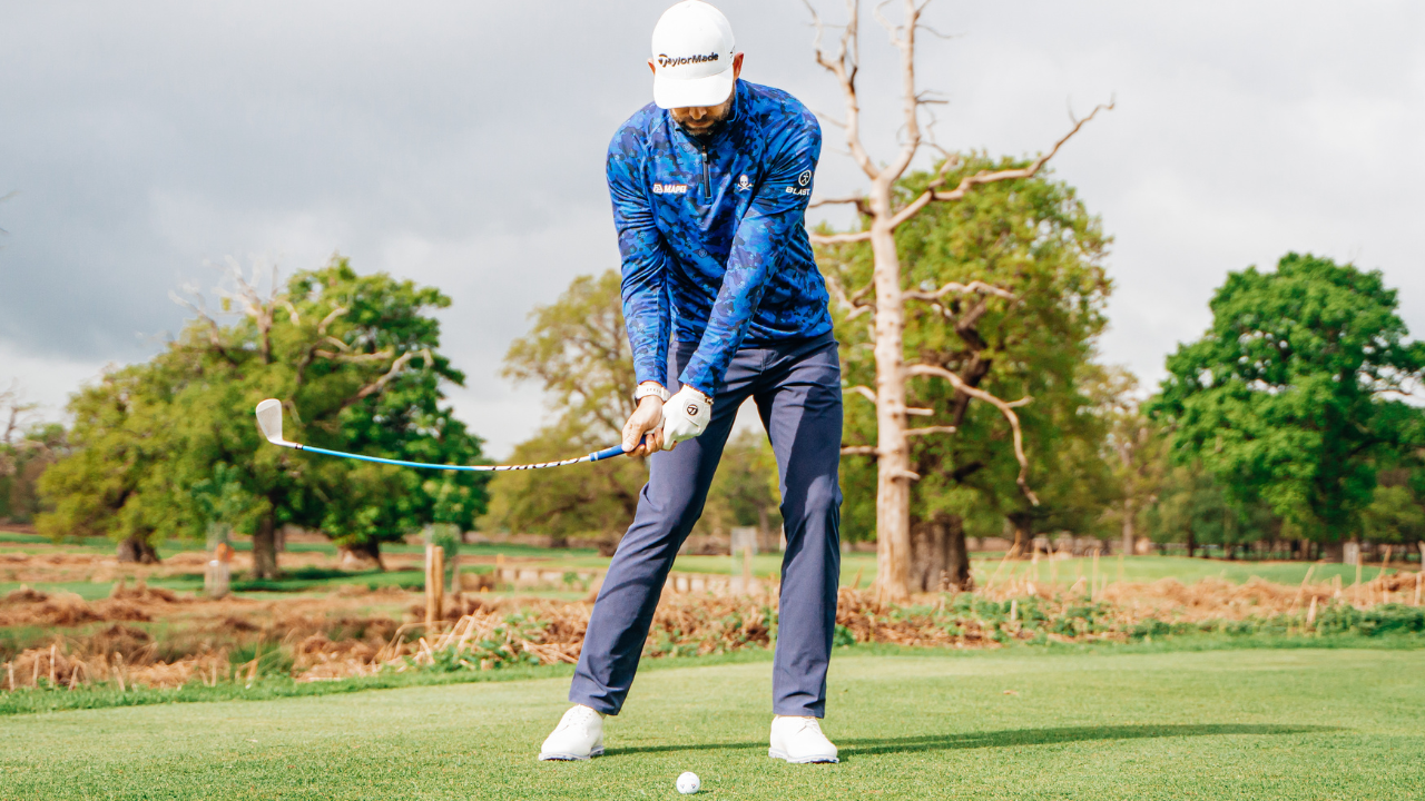 Professional golf coach Chris Ryan swinging the gforce swing trainer golf club during the downswing position on the golf course